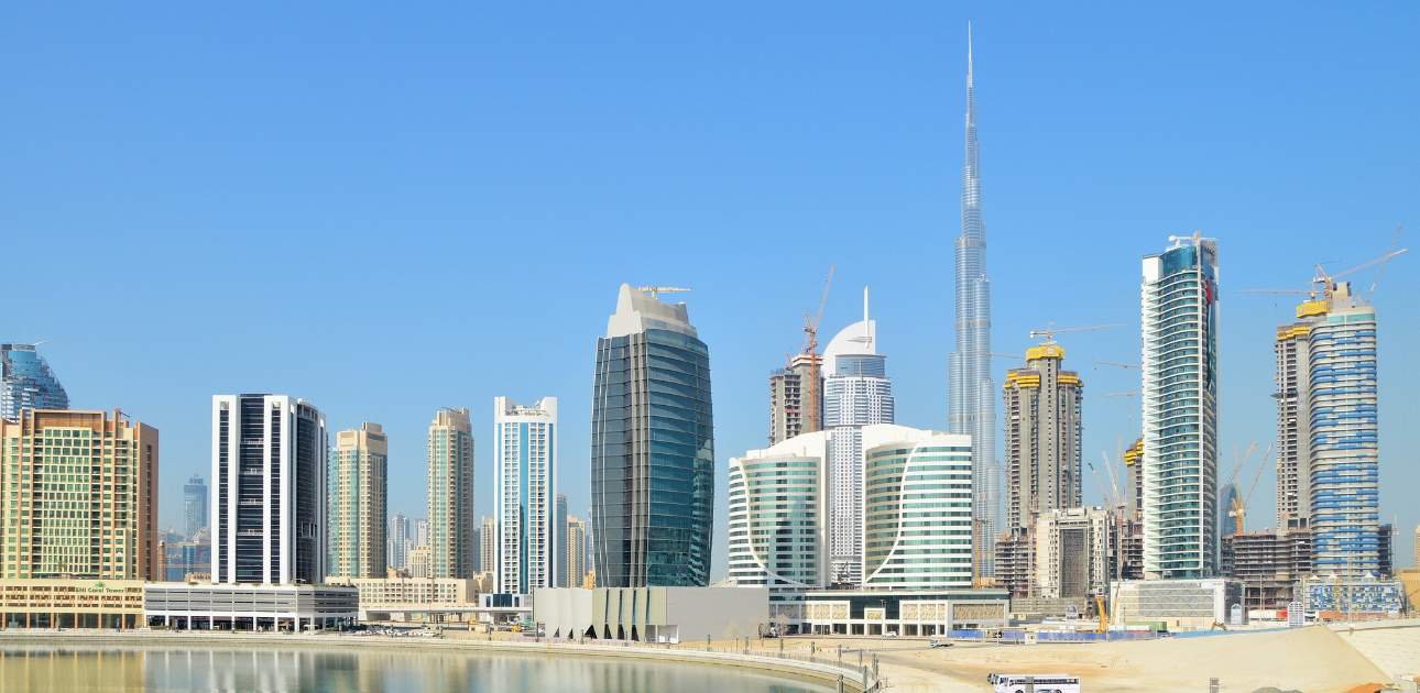 Modern Dubai skyline with high-rise buildings and waterfront view, representing the financial and business hub of DIFC