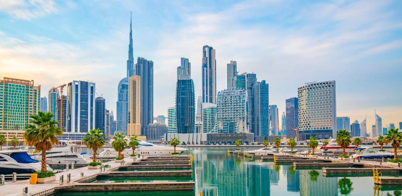 Scenic view of Dubai’s waterfront skyline with luxury yachts and modern skyscrapers, representing trade and business opportunities in SAIF Zone