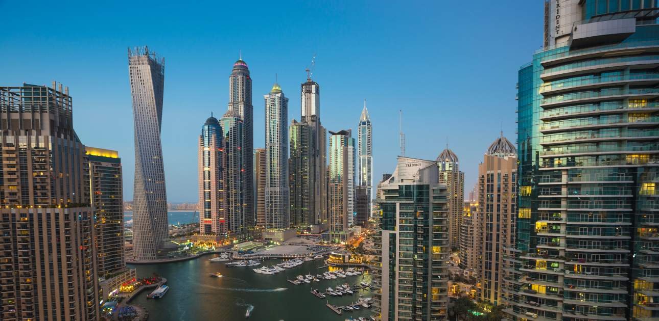 Modern Dubai skyline with high-rise buildings and waterfront view, representing the financial and corporate landscape ideal for establishing a Holding Company SPV in the UAE.