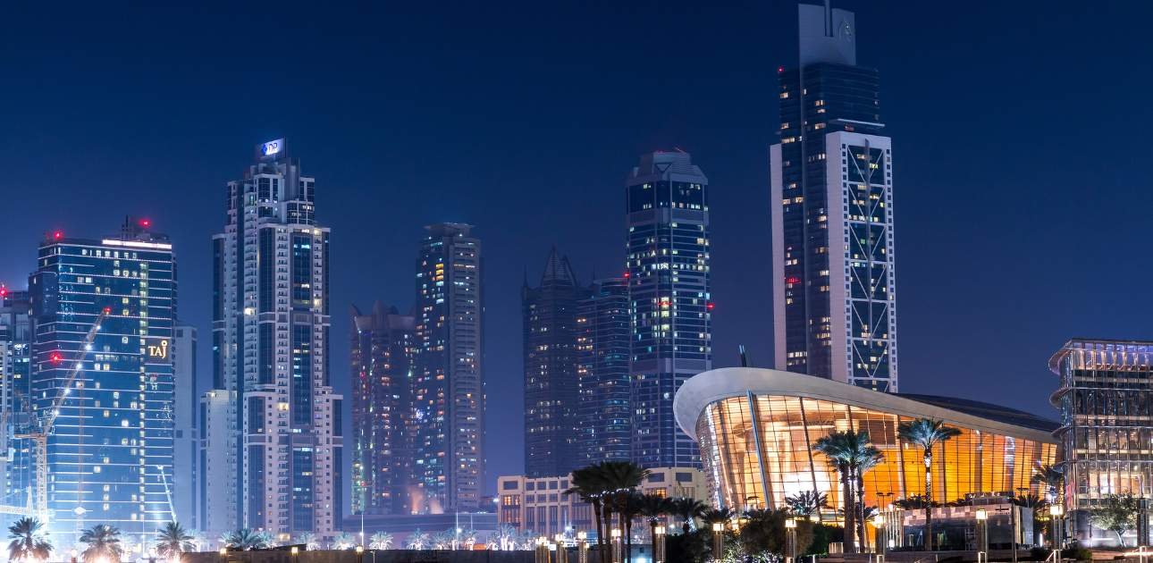 Modern Dubai skyline at night showcasing illuminated skyscrapers and business towers, symbolizing financial growth, asset protection, and wealth management under UAE Trusts.