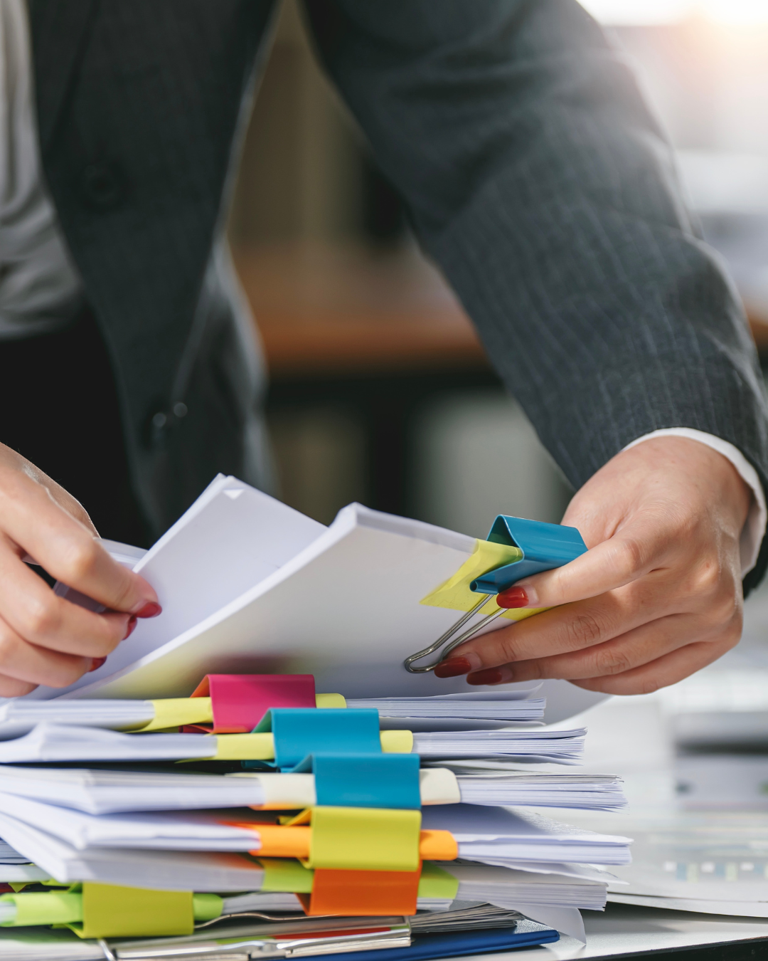 A professional organizing official documents with colorful clips for MOFA Attestation in the UAE, ensuring proper verification and legal authentication.